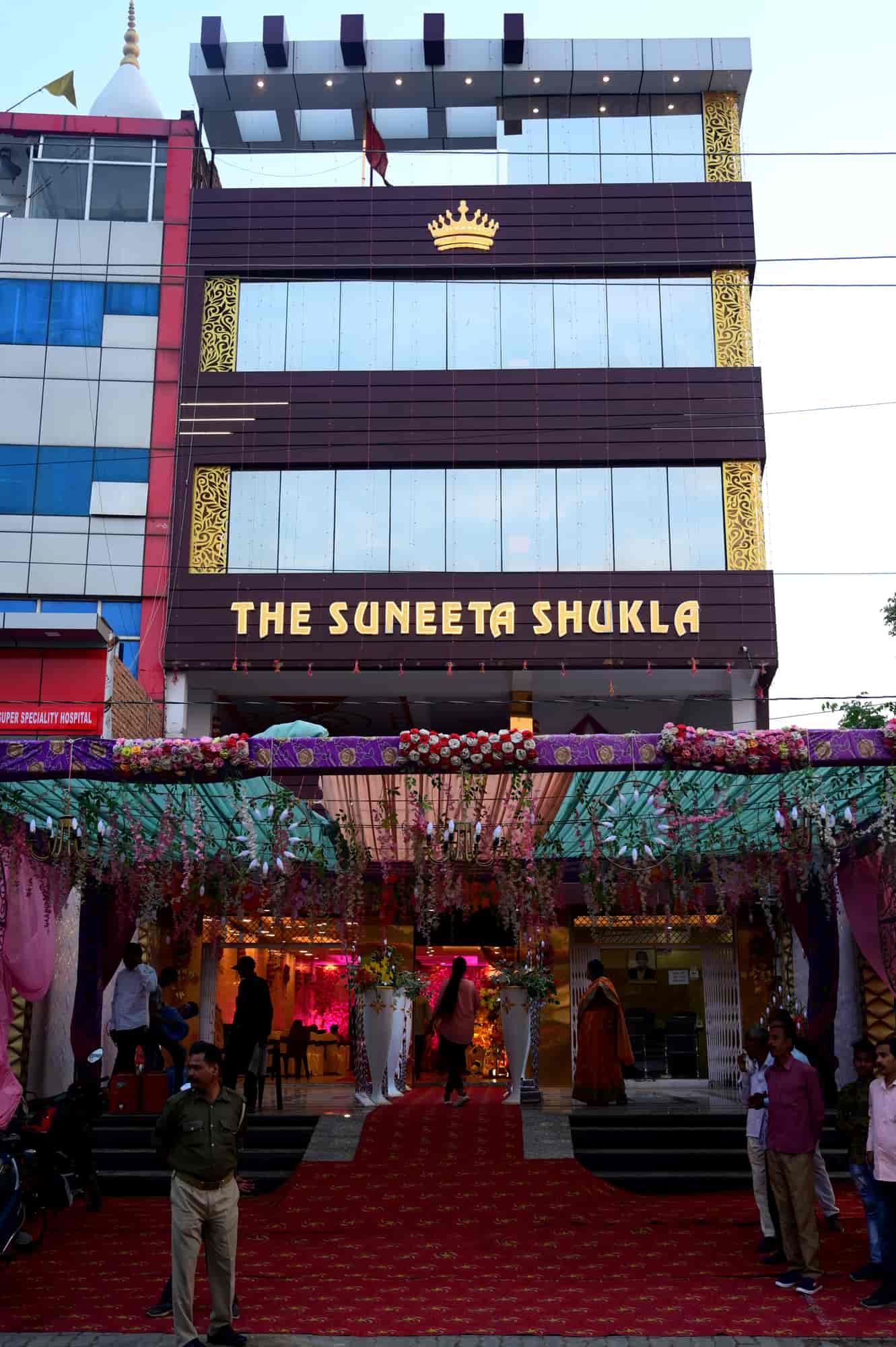The building in daylight with a red carpet entrance