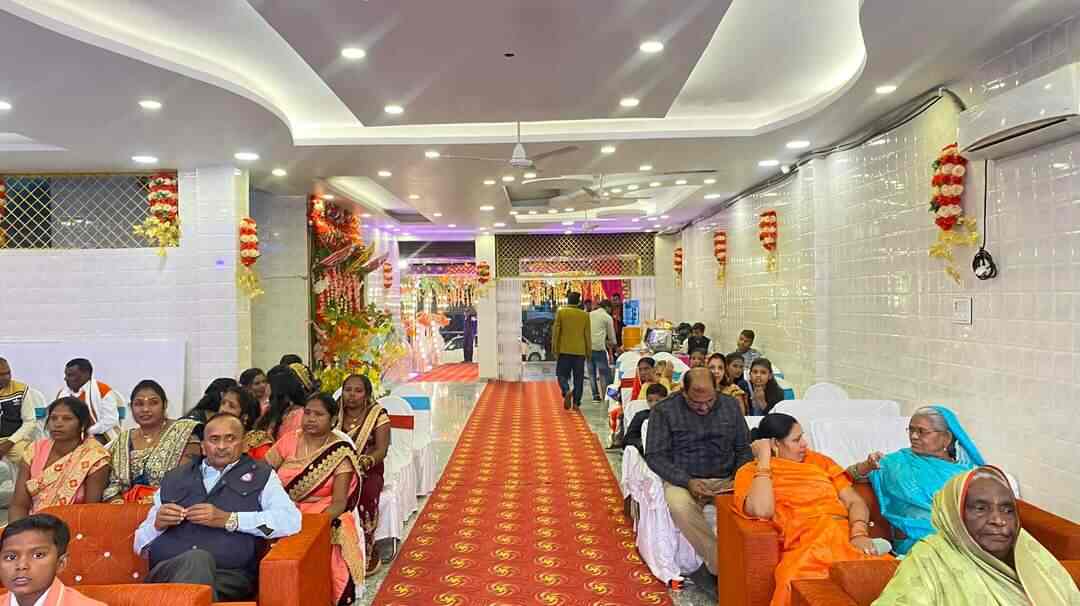 AC hall decorated with marigolds during an event
